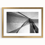Textured abstract art print in gold frame, featuring a blend of swirling gray and white tones, suitable for bedroom decor.