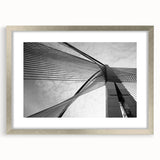 Abstract art print featuring geometric shapes in muted gray and blue tones on a framed silver mat.