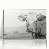Framed acrylic wall art featuring a minimalist cow design in a white frame, showcasing a modern aesthetic perfect for animal lovers and contemporary decor.