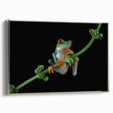 Framed wall art featuring a vibrant green frog design on textured canvas, displayed with a sleek silver frame, perfect for nature-inspired decor.
