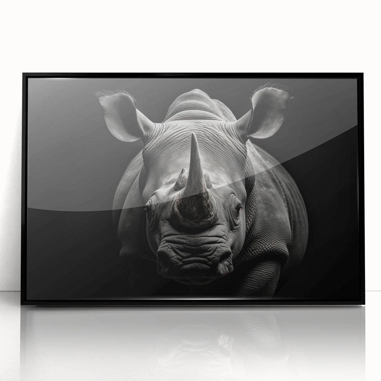 Framed wall art showcasing a striking black and white rhinoceros design, perfect for wildlife enthusiasts, displayed in an elegant acrylic frame, adding a modern touch to home decor.