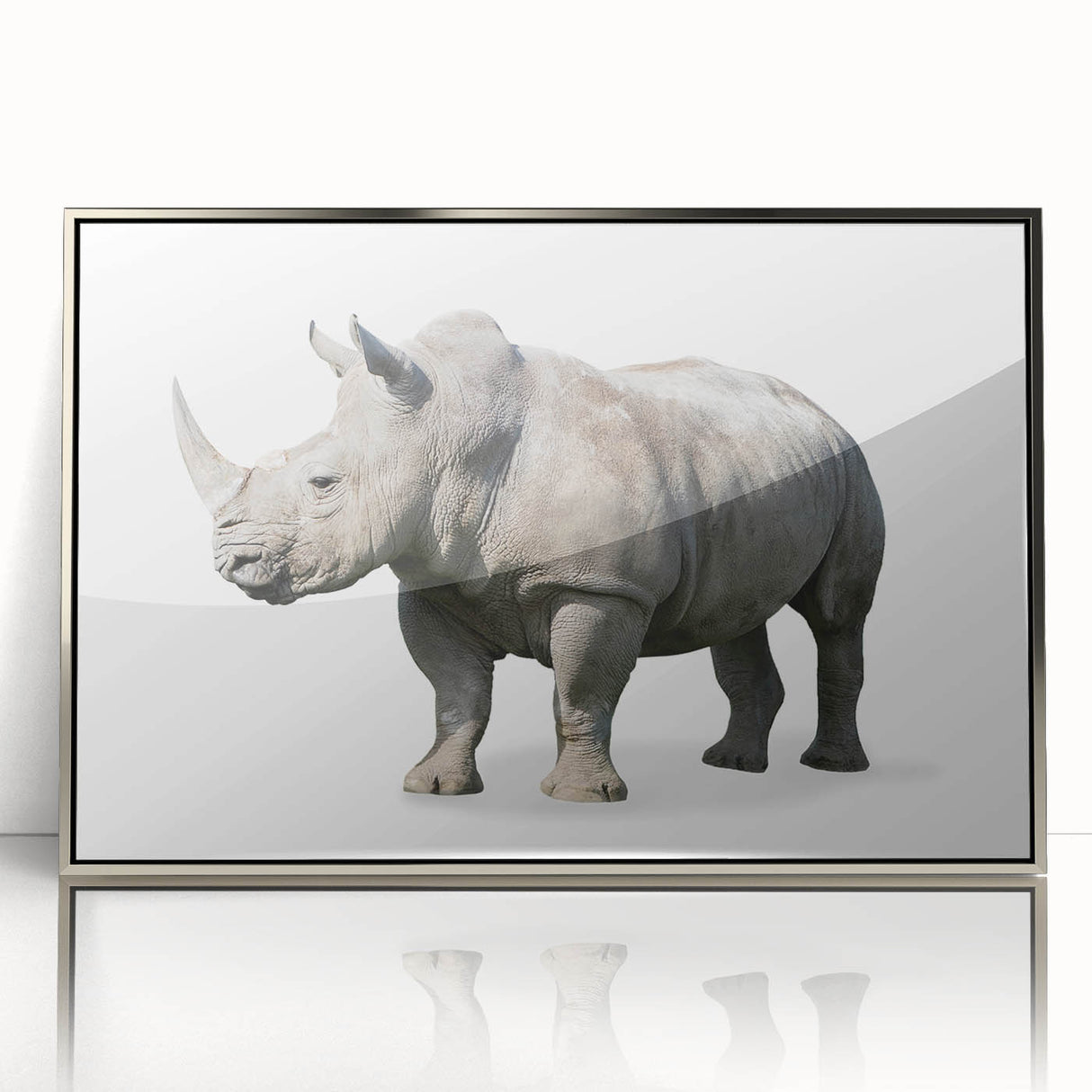 Framed wall art featuring a striking silver-accented rhinoceros design, showcasing intricate details and textures, perfect for animal lovers and modern decor enthusiasts.