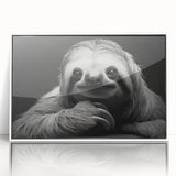 Framed wall art featuring a sloth design in vibrant colors, set against a white background, perfect for adding a whimsical touch to any room decor.
