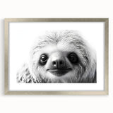 Sloth-themed wall art print featuring a whimsical sloth design in a silver frame with a white mat, perfect for animal lovers and home decor enthusiasts.