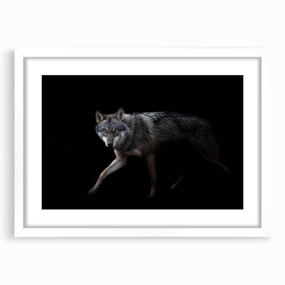 Framed wall art featuring a striking wolf design in a minimalist style, with a white mat and frame, perfect for nature-themed home decor. Ideal for animal lovers seeking to enhance their living space's aesthetic.