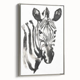 Framed wall art featuring a striking zebra design on a textured canvas, showcasing bold black and white stripes, elegantly displayed with a silver frame, perfect for adding a touch of wildlife-inspired decor to modern interiors.