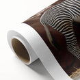 Rolled canvas print showcasing a striking zebra design with vibrant black and white stripes, ideal for wildlife-themed decor, packaged securely for easy display.