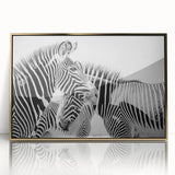 Framed wall art featuring a striking zebra design in bold black and white, set in a sleek gold frame, perfect for enhancing modern decor and animal-themed interiors.