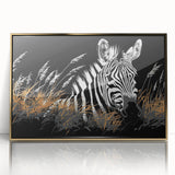 Framed wall art showcasing a striking zebra design in black and white, complemented by a sleek gold frame, perfect for modern decor and animal lovers.