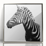 Framed wall art featuring a striking zebra design in a silver acrylic frame, showcasing bold black and white stripes, perfect for wildlife enthusiasts and modern decor.