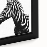 Close-up of a framed canvas wall art featuring a striking zebra design, showcasing intricate details and vibrant black and white patterns, perfect for animal lovers and modern decor.