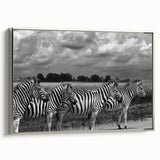 Framed wall art featuring a striking zebra design in black and white, elegantly displayed from a silver side view, enhancing modern decor with a wildlife theme.