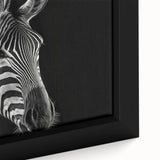 Close-up of a framed canvas print showcasing a striking zebra design, featuring bold black and white stripes, perfect for wildlife enthusiasts and modern décor.