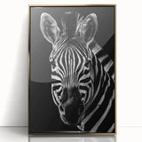 Framed acrylic wall art showcasing a striking zebra design in black and white, set against a gold backdrop, perfect for adding a touch of wildlife elegance to home decor.