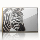 Framed wall art featuring a striking zebra design in vibrant black and white colors, set against a luxurious gold frame, perfect for adding a touch of wildlife elegance to home decor.