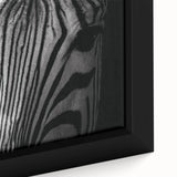 Close-up of a framed canvas wall art featuring a striking zebra design, showcasing intricate black and white stripes. Ideal for animal lovers and modern decor enthusiasts, this vibrant piece adds a touch of wildlife charm to any space.