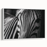 Framed canvas wall art showcasing a striking zebra design in black and white, set against a minimalist white background, perfect for modern decor.
