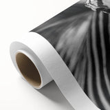 Zebra-themed rolled canvas wall art featuring bold black and white stripes, showcasing a modern design perfect for home decor, packaged securely for delivery.