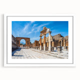 Abstract art print of ancient ruins in muted beige and gray, framed with a white mat, suitable for dining room decor.