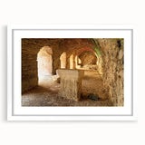 Abstract art print of ancient ruins in muted earth tones on a white framed canvas, suitable for dining room decor.