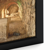 Framed canvas of a black wall art featuring ancient ruins with colorful, textured detailing.