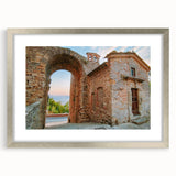 Textured art print of ancient ruins in muted earth tones on a silver-framed mat, suitable for bedroom decor.