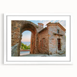 Abstract art print of ancient ruins in muted earth tones on a white-framed canvas, suitable for bedroom or dining room decor.