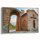 Framed canvas of vintage poster art depicting ancient ruins in a landscape, blending black with colorful accents.