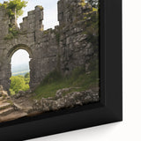 Close-up of a black wall art featuring ancient ruins in colorful, textured design on a framed canvas.