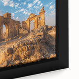 Close-up of a black framed canvas featuring colorful, textured art of ancient ruins, ideal for living room decor.