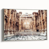 Framed canvas featuring a landscape painting of ancient ruins in muted earth tones.