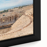 Close-up of a black framed canvas featuring textured, colorful art of ancient ruins, ideal for living room decor.