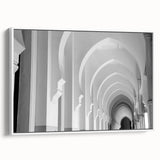 Framed canvas featuring a vintage poster art of colorful landscape with black arches.