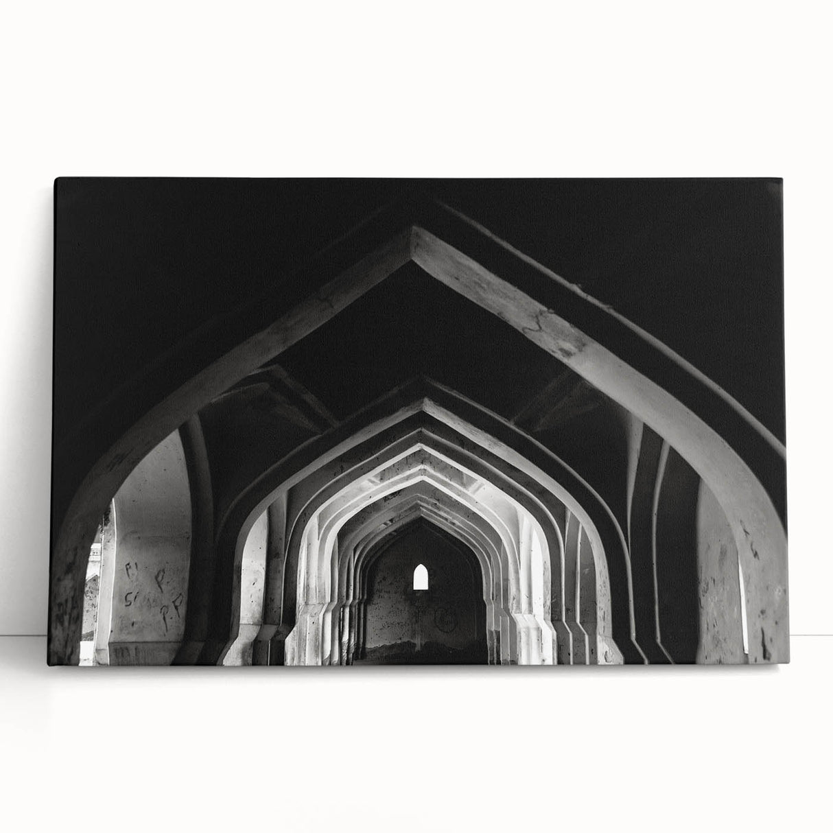 Black and white photograph of architectural arches printed on large stretched canvas.