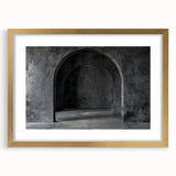 Abstract art print featuring curved arches in muted gold and cream tones, framed with a gold mat.