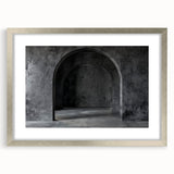 Textured art depicting abstract arches in muted earth tones on a framed silver mat, suitable for bedroom decor.