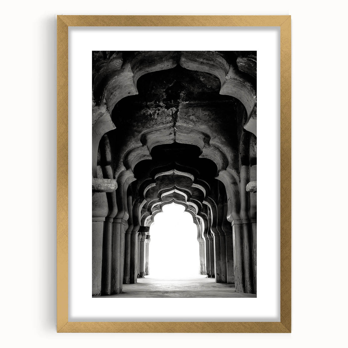 Abstract art print featuring symmetrical arch designs in muted gold and white, framed with a gold mat.
