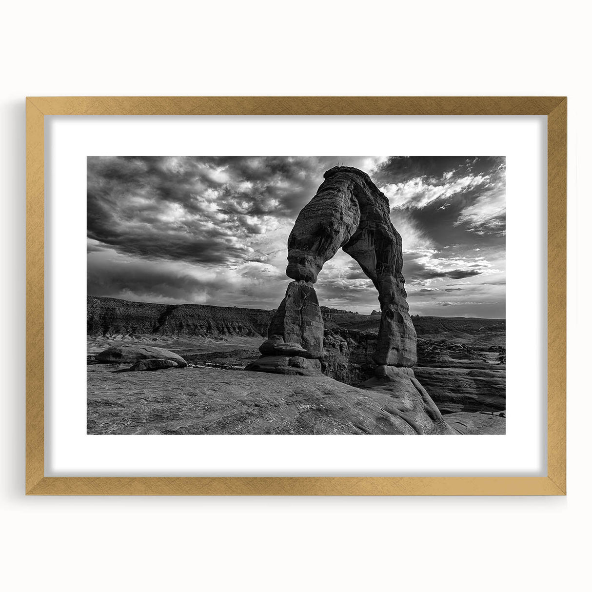 Abstract art print featuring a series of overlapping arches in muted gray and gold tones, framed in gold.