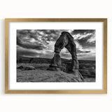 Abstract art print featuring a series of overlapping arches in muted gray and gold tones, framed in gold.