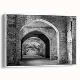 Framed canvas depicting an archway in muted black and gray, ideal for adding a vintage touch to any room.