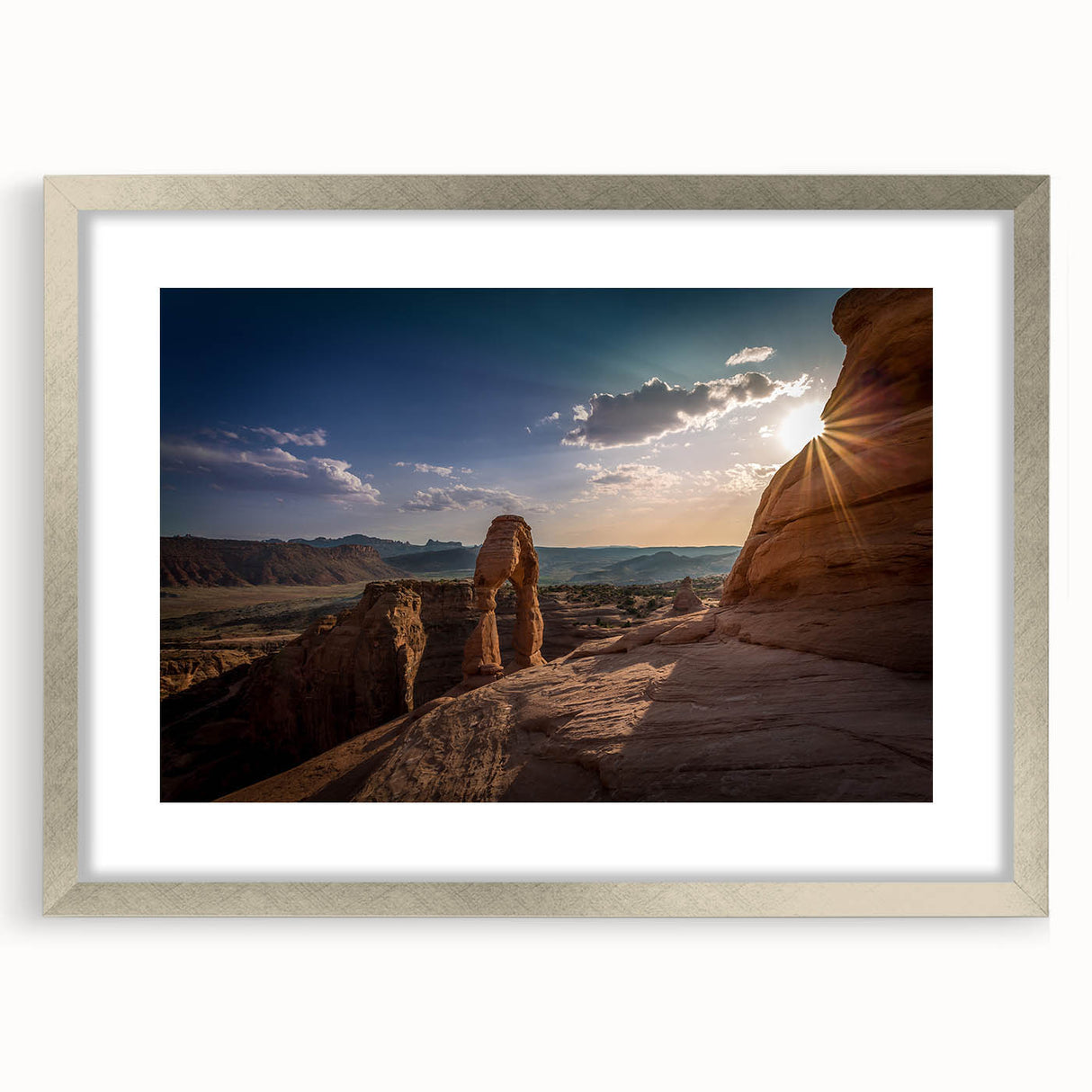 Textured abstract art print featuring curved architectural forms in neutral shades, silver-framed with mat.