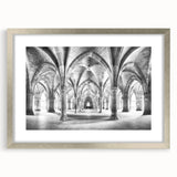 Textured abstract art print featuring curved architectural forms in gray, mounted in a silver frame.