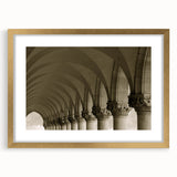 Abstract art print featuring interconnected arches in gold and black tones on a framed canvas.