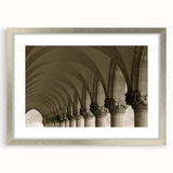 Textured art print of abstract arches in cool gray tones, framed in silver, ideal for bedroom wall decor.
