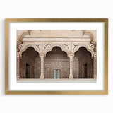 Abstract art prints of architectural arches in muted gold tones on a framed canvas.