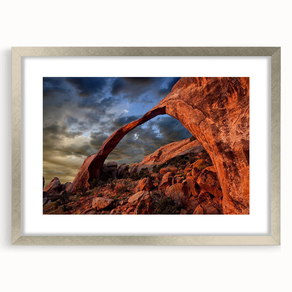 Textured art print of abstract arches in soft gray tones on a framed silver mat, suitable for bedroom decor.