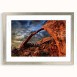 Textured art print of abstract arches in soft gray tones on a framed silver mat, suitable for bedroom decor.