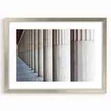 Textured art print of abstract columns in muted gray, framed in silver, ideal for modern bedroom ambiance.