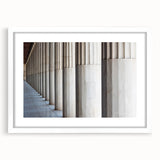 Abstract art print featuring a series of white columns in various geometric patterns on a framed poster.