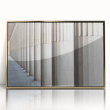Large art print of classical columns in gold tones on acrylic, styled in mid-century modernist design.